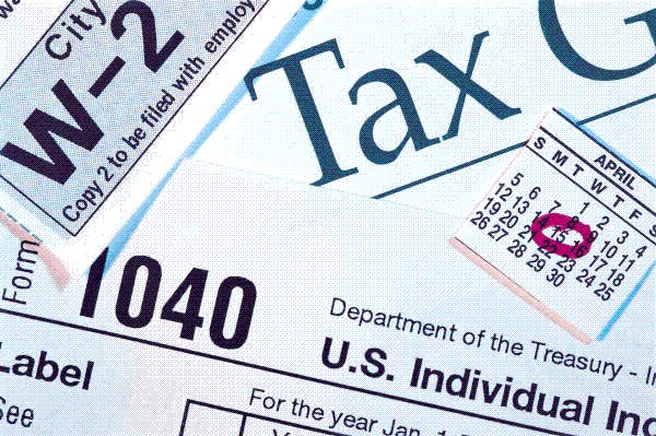 collage of images related to tax returns containing pieces of W2 and 1040 forms and an April calendar page with the 15th date circled in red